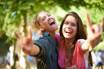 Fototapeta premium Girls day out. Two female friends hugging while standing outside.