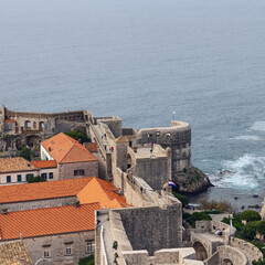fortress walls, red roofs of houses and a quiet bay in the Croatian city of Dubrovnik - 581183712
