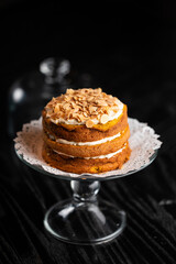 Closeup of a delicious cake with cream on a black background