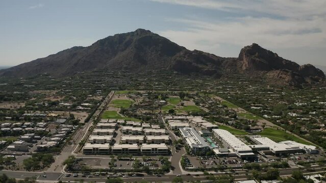Aerial view of Camelback Mountain and private golf community and surrounding landscape and neighborhoods in Scottsdale, Arizona - 4K Drone