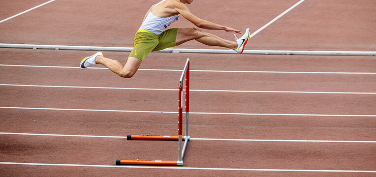 athlete runner running 400 meters hurdles, Nike spikes shoes and tights, summer sports games