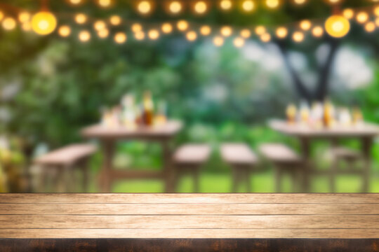 Empty wooden table with party in garden background blurred Generative AI