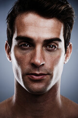 Fototapeta premium He just oozes confidence. Closeup studio portrait of a handsome young man.