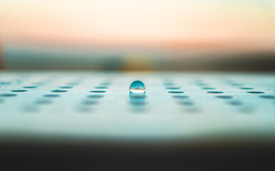a glass ball on a metal seat with sunshine background
