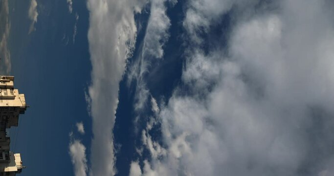 Demonstration of polarized filter effect on the sky with clouds, vertical video