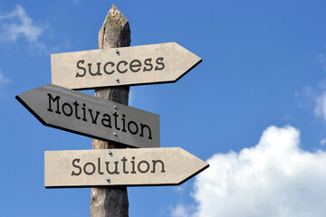 Success, motivation, solution - wooden signpost with three arrows, sky with clouds