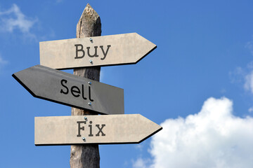 Buy, sell, fix - wooden signpost with three arrows, sky with clouds