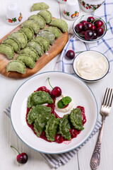 Homemade cherry dumplings (pierogies) with cherry sauce.