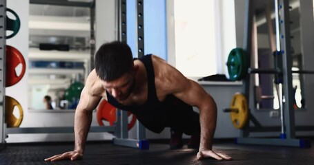 Man doing clap plyometric push ups at the gym