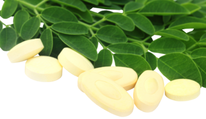 Moringa pills with flower and leaves