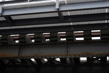 Detail of the railway crossing photographed from below. We can see the individual sleepers and the...