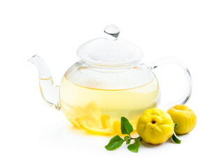 Hot quince tea in transparent teapot with fresh fruits isolated on white