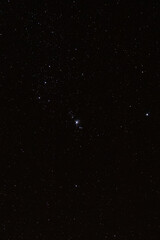 The Orion Nebula on a field of stars in the night sky.