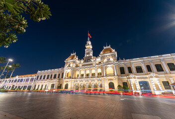 Fototapeta na wymiar Traffic in front of Ho Chi Minh City Hall, Saigon City Hall or Committee Head office in the evening, Vietnam. Light trail and night. Popular place to visit in Saigon