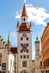 View at the tower of the old town hall and toy museum at Marienplatz pedestrian zone in munich city downtown - obrazy, fototapety, plakaty
