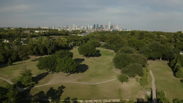 Aerial view of golf course park landscape with Dallas, Texas skyline in Oak Cliff neighborhood - 4K Drone