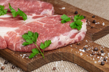 Raw fresh meat. Raw pork steak on a wooden board.