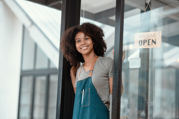 Fototapeta premium Small business owner standing at the cafe entrance, Young African American Woman Cafe Owner. 