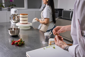 Close-up of a professional chef's hands working with fruit.