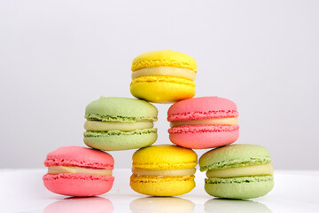 Fototapeta na wymiar Close up of colorful macarons cakes. Small French cakes. Sweet and colorful dessert with vintage pastel tones. . High quality photo