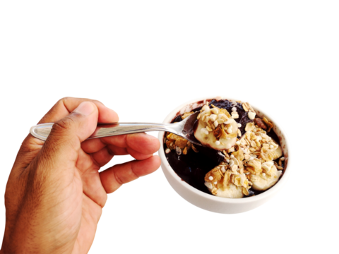 hand grabbing açaí (acai) of the bowl