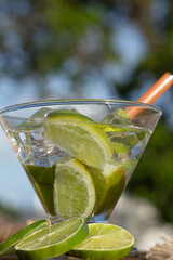 brazilian drink (caipirinha) with lemon and ingredients around