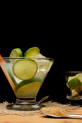 brazilian drink (caipirinha) with sugar and ingredients around