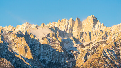 Fototapeta premium Panoramic view of Mount Whitney peak with snow and glaciers during sunrise in the Alabama Hills, California USA