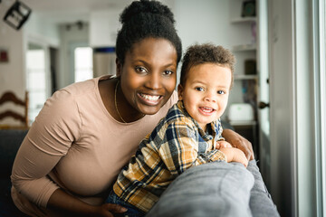 Mother and Son having fun on sofa Together