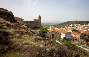 Fototapeta na wymiar a view of the clock tower on the castle wall and Penamacor town, district of Castelo Branco, Beira Baixa, Portugal - October 2022