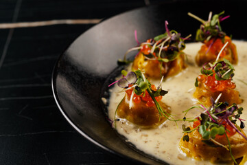 dumplings with caviar in a creamy sauce