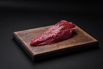 Beautiful fresh piece of raw beef on a wooden cutting board