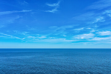 Fototapeta premium Tranquil Mediterranean Sea with Blue Water and Light Clouds - A Serene Summer Scene