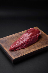 Beautiful fresh piece of raw beef on a wooden cutting board