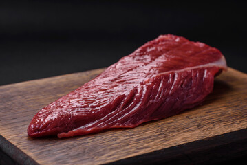 Beautiful fresh piece of raw beef on a wooden cutting board
