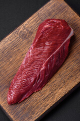 Beautiful fresh piece of raw beef on a wooden cutting board