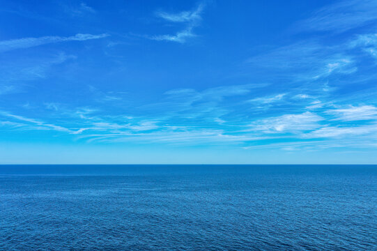 Tranquil Mediterranean Sea with Blue Water and Light Clouds - A Serene Summer Scene