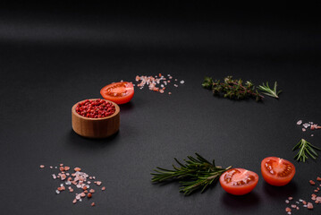 Obraz na płótnie Canvas Rosemary, thyme, allspice, salt, cherry tomatoes and other spices and herbs