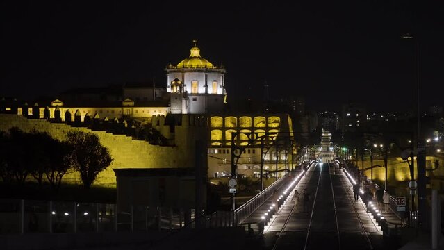 Night city view with amazing architecture. Action. Building with yellow illumination on a black sky background.