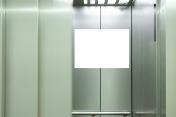 Mock up. Vertical poster media template frame hanging on the wall inside elevator lift