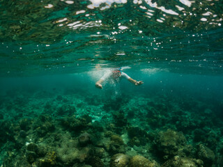 Naklejka na ściany i meble woman snorkeling in clear tropical sea