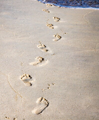 footsteps in golden sand texture summer fun