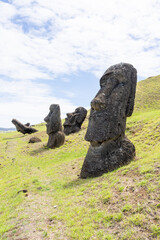 Moai statues on the slope of Rano Raraku on Easter Island (Rapa Nui),  Chile. Rano Raraku is commonly known as the “Moai Factory” with hundreds of abandoned statues scattered around.