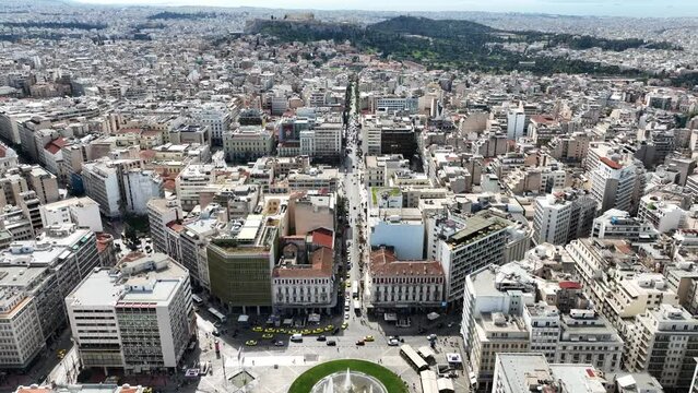 Aerial drone video of famous urban busy round square of Omonia in the heart of Athens historic centre, Attica, Greece