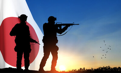 Fototapeta na wymiar Silhouettes of a soldiers on background of sunset with Japan flag. Japan Armed Force Concept. EPS10 vector