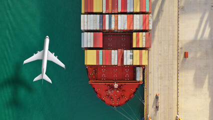 Aerial drone top down concept photo of container terminal and plane flying above indicating popular cargo means of transport