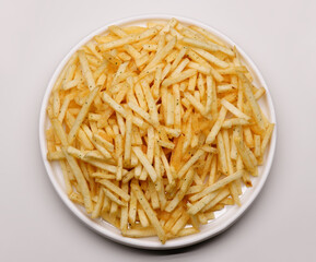 French fries background, closeup shot. Delicious potatoes with a golden fried crust. French fries background. Potato straw
