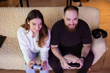 young married couple is addicted to virtual games and spends a lot of time together playing on...