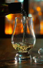 Pouring in tulip-shaped tasting glass Scotch single malt or blended whisky