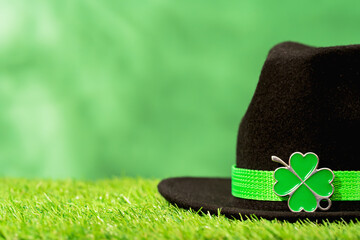St Patricks Day side border shamrock on hat. Four leaf clover. Party hat in vibrant green color